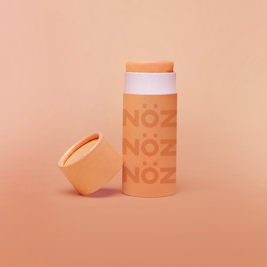 Nöz vibrant orange tube of "Orange Crush"  cruelty-free and vegan sunscreen