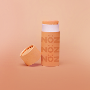 Nöz vibrant orange tube of "Orange Crush"  cruelty-free and vegan sunscreen